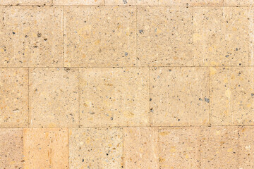 polished light brown tuff stone tiles on wall