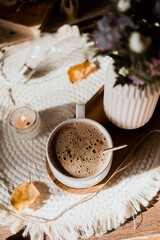 mocha coffee in white cup with foam, golden spoon, morning coffee in sunlight, autumn leaves, pink asters, autumn flowers, breakfast, candles