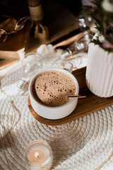 mocha coffee in white cup with foam, golden spoon, morning coffee in sunlight, autumn leaves, pink asters, autumn flowers, breakfast, candles