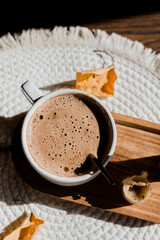 Mocha coffee in a white flatlay cup, autumn coffee, morning routine, coffee in the sunlight, wax...