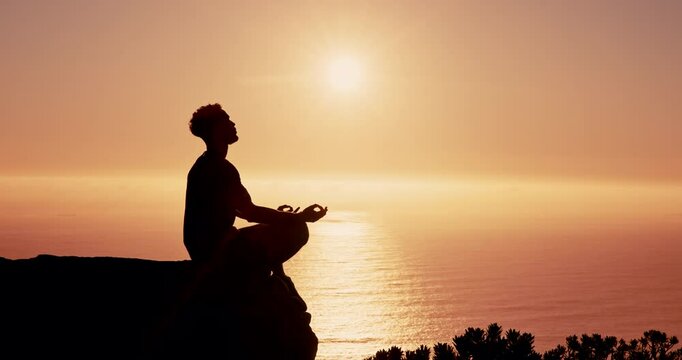 Person, meditation and silhouette on mountain by sunset sky with mindfulness, lotus and mockup space in nature. Breathing, sunshine and outdoor on cliff with zen balance, yoga or ocean in New Zealand