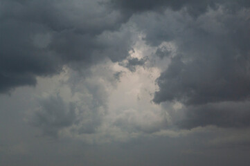 dark gray cumulonimbus and nimbostratus clouds with a bright grey gape in the middle