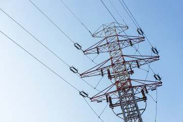 Transmission tower background. High voltage electricity pylon. Metal construction and blue sky. Power lines background. Energy distribution texture. Steel industry texture.