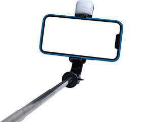 Selfie stick and smartphone on white background with white cut out screen.
