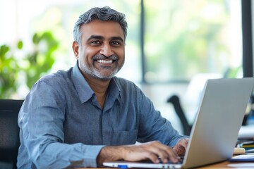 Smiling mature business man executive wearing shirt sitting at desk using laptop. Happy busy professional middle aged Indian businessman investor working on computer looking away in office, ai