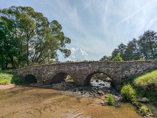 A historical and scenic old medieval stone bridge Most U Lutriana by Havlickuv Brod in Vysocina region offers a picturesque view and a glimpse into traditional Czech architectural beauty and heritage