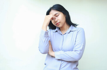 depressed asian woman feeling unwell tired having headache touching forehead with folded arm...
