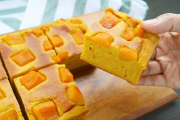 Hand Holding a Slice of Delectable Homemade Butternut Squash Cake