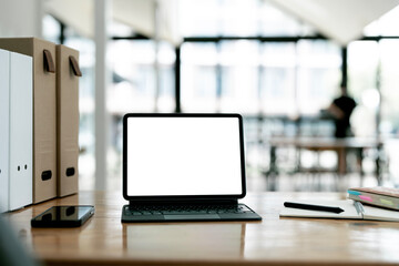 Laptop with empty white screen mockup. Office space interior.