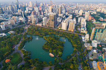 Naklejka premium Aerial view modern city office building downtown of Bangkok with green public tropical park
