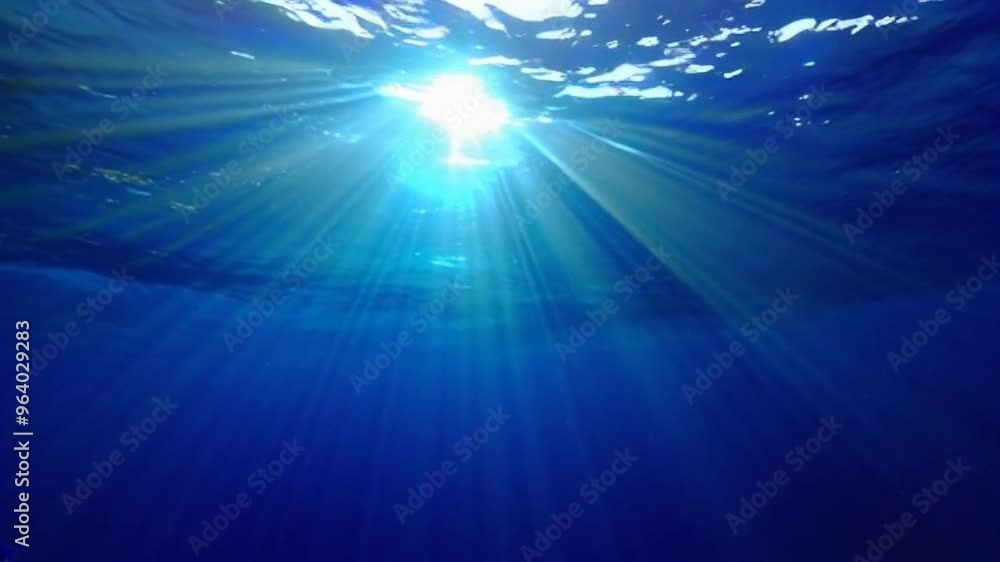 Poster underwater scene with sunlight piercing through the surface, creating a tranquil and serene atmosphe