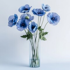 A bouquet of blue flowers in a clear vase against a light background. © boztaga
