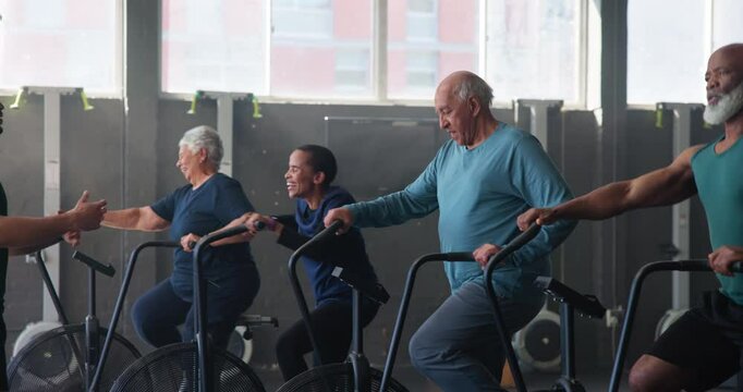 People, fitness center and exercise bike for endurance, wellness and strong muscle in studio, class or gym. Group, instructor and elliptical machine for cycling sports, workout and physical training