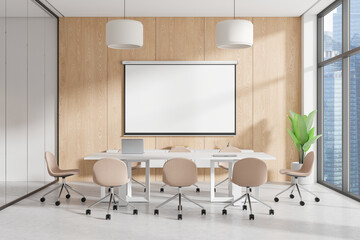 Modern office conference room with beige chairs around a white table, a blank screen on a wooden wall, large windows, and city view. Business concept. 3D Rendering