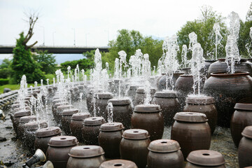 View of the fountains in the shape of the traditional Korean ceramic container, spraying water 