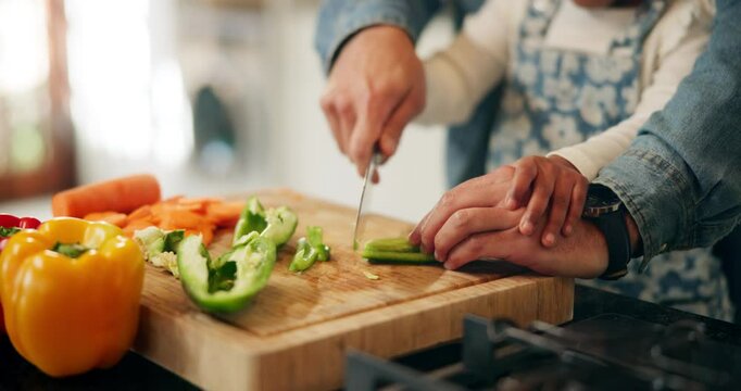 Hands, child and parent cutting vegetables for food, learning and cooking healthy lunch in home kitchen. Teaching, kid and chopping board with knife closeup for pepper, organic meal and girl help