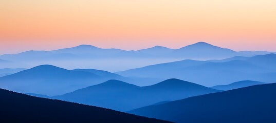 Obraz premium A serene, mountain landscape at dusk with a clear sky and text space