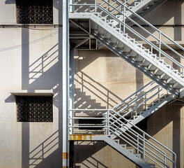 Architecture details of outdoor fire escape staircase in old and rusty condition with beautiful shadow © PIRAK