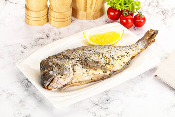 Baked Dorado fish served lemon