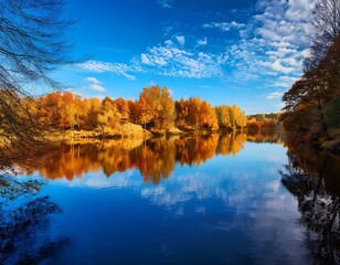 Fototapeta premium Autumn landscape with blue sky and clouds over the river; reflection in water; beautiful lake