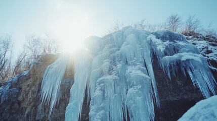breathtaking winter landscape with an icy waterfall cascading over the edge of a cliff, reflecting vibrant colors under a sunset sky, with a person in the foreground