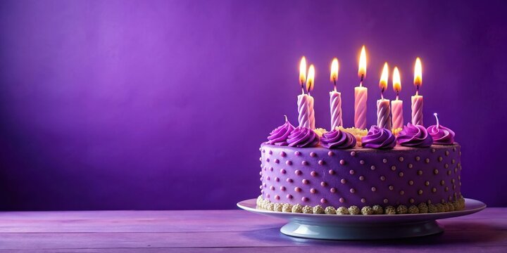 Purple birthday cake with lit candles and plenty of copy space for a festive celebration