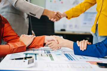 Two confident business man shaking hands during a meeting in the office, success, dealing