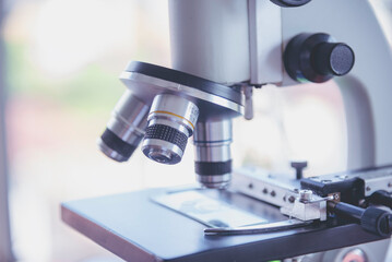 Science microscope equipment in biology chemical laboratory. Scientific experiment Microscope on Lab table microbiology equipment. Chemistry objects on lab background. Chemistry scientific concept