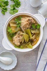 Pickled Lettuce Soup with Pork Rips in white bowl
