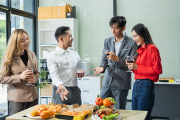 Asian business team are excited business success with inspiration from their excellent financial results, celebration successful deal with champagne and pizza in the workplace.