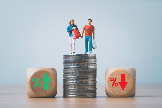 Man and woman shopping on coins standing of the top of coins stacking with up and down percentage for consumer price index concept.