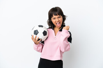 Young mixed race woman isolated on white background with soccer ball celebrating a victory