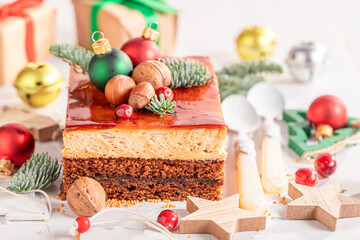 Homemade Christmas cake with gingerbread and caramel glaze..