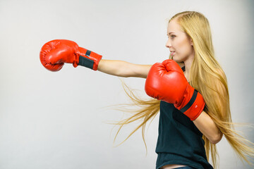 Woman in red gloves boxing