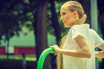 Female doing exercise in outdoor gym