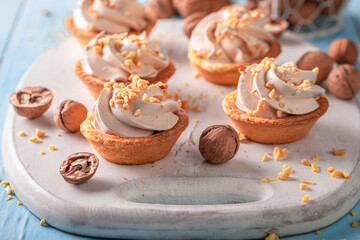 Homemade mini tartlets with nuts and vanilla cream.