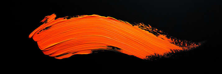 bright orange brush stroke of paint on black background