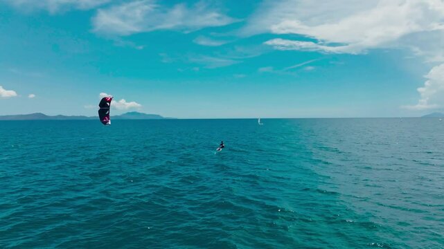 Kitesurfing in the ocean on a sunny day