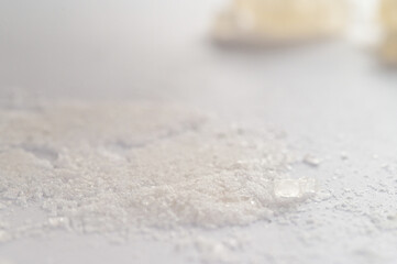 World Drug Day. World AIDS Day. Conceptual image of bath salts synthetic cathinones drugs narcotics concept. White crystal powder, crystals and lines on white background