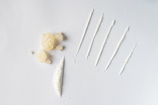 World Drug Day. World AIDS Day. Conceptual image of bath salts synthetic cathinones drugs narcotics concept. White crystal powder, crystals and lines on white background