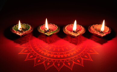 Diwali Deepavali Hindu festival of lights celebration. Diya oil lamp on red background