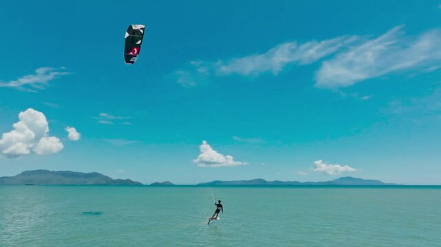 Kitesurfing in the ocean on a sunny day
