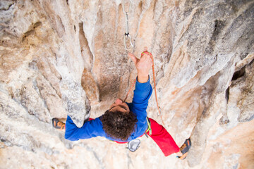 A rock climber ascends to the summit via a difficult route.