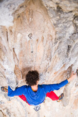 A rock climber ascends to the summit via a difficult route.