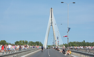 Crowd of people on the Swiętokrzyski bridge in the center of Warsaw during the holidays in a sunny day. 