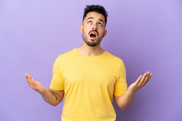 Young caucasian man isolated on purple background stressed overwhelmed