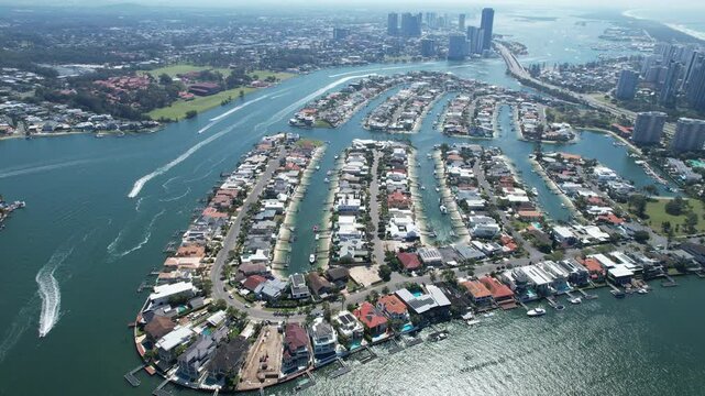 Drone footage of the Gold Coast in Queensland, Australia, featuring city skyscrapers, canals, and coastline. Captured on a sunny day, showcasing the vibrant urban landscape, waterways, Surfers Paradis