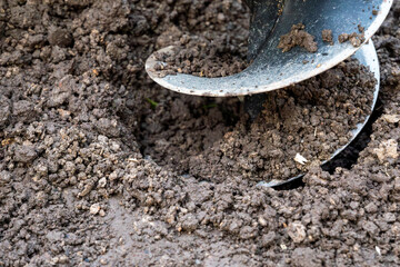 Tool hand-held soil hole drilling machine for prepare the soil for planting shrubs or trees, or for construction work.