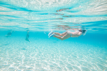 Girl snorkelling in the clear waters of Blue Lagoon in Malta Island