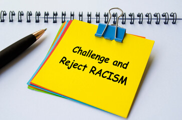 Challenge and Reject RACISM text on yellow notepad. No to negativity concept